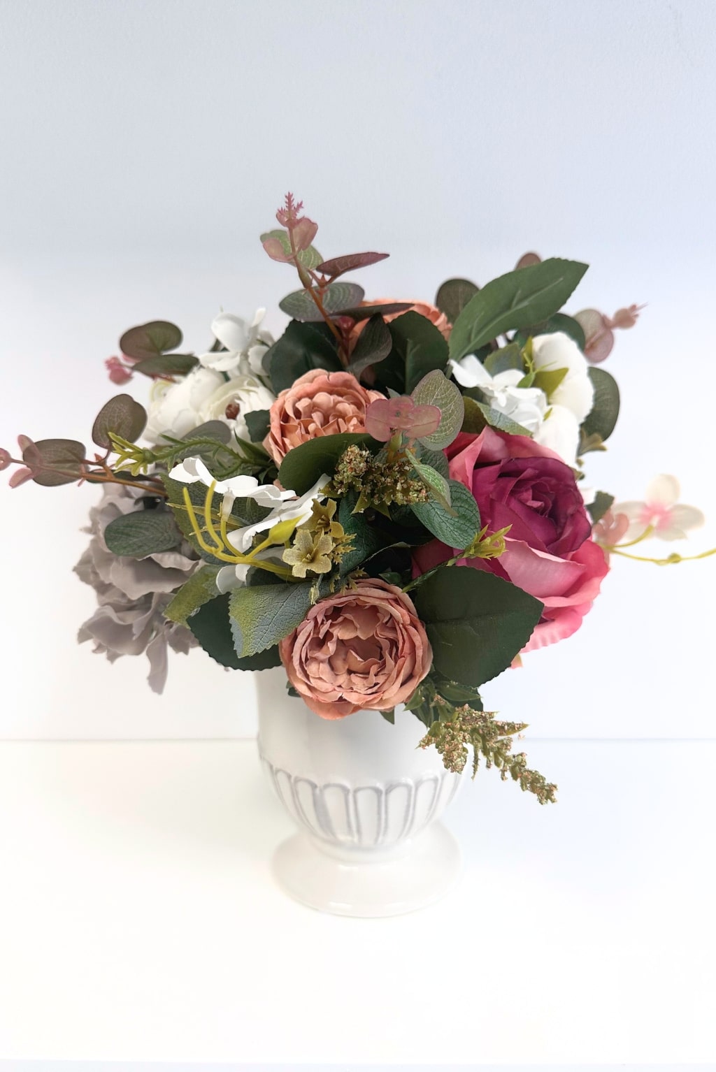 Flowers in vintage colors in a ceramic pot